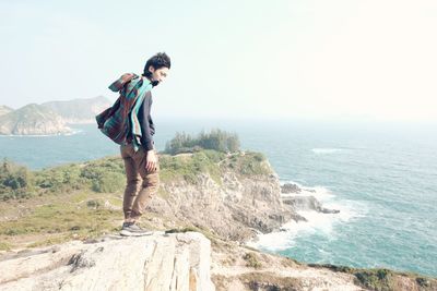 Side view of a man overlooking calm sea