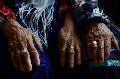 Midsection of senior women wearing rings