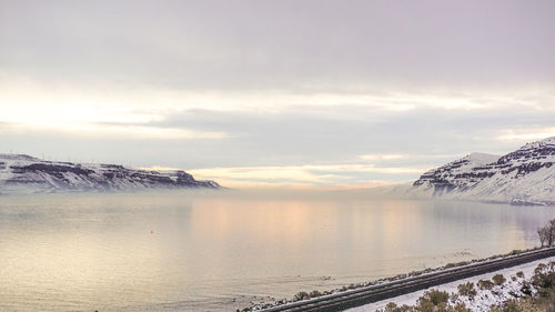 Scenic view of lake against sky during sunset