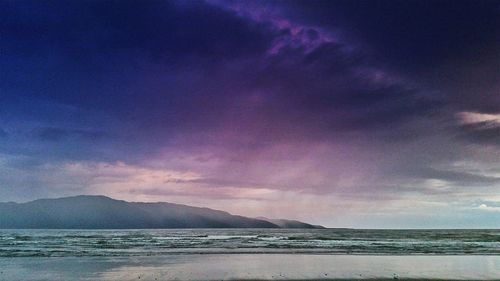 Scenic view of sea against cloudy sky