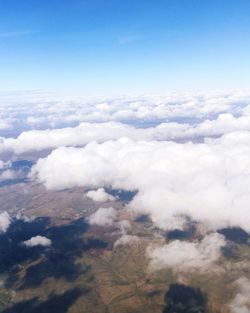 Aerial view of clouds over landscape against sky