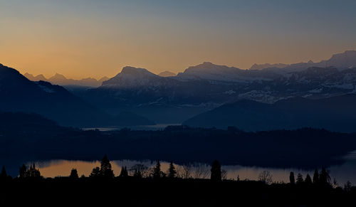 Scenic view of silhouette mountains against sky during sunset