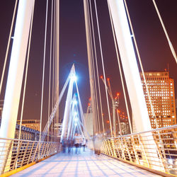 Illuminated suspension bridge at night