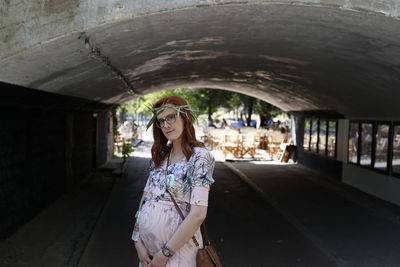 Young woman standing in corridor of building