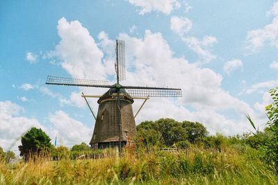 Low angle view of windmill against sky