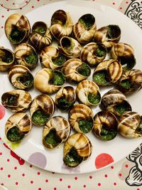 High angle view of shells in plate on table