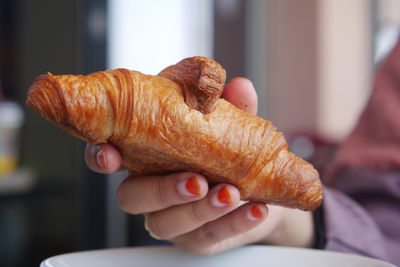 Cropped hand of man holding food