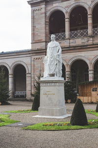 Statue against historic building