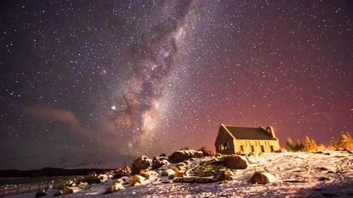Panoramic view of buildings against sky at night