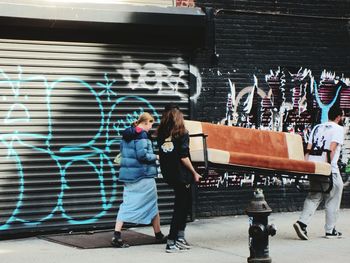 Full length of woman standing by railing