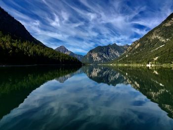 Scenic view of lake plansee and mountains against sky 