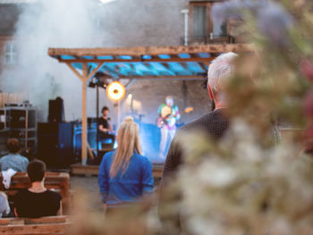 Rear view of man standing in factory