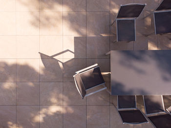 Aerial view of a garden furniture on a sunny terrace. high angle view of chairs on tiled floor 