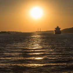 Scenic view of sea against orange sky