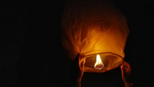 Close-up of illuminated lantern against black background