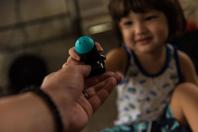 High angle view of young boy and father hand