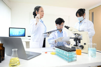 Side view of doctor examining chemical in laboratory