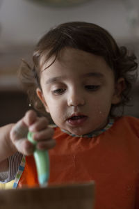 Close-up portrait of cute girl holding a scoop