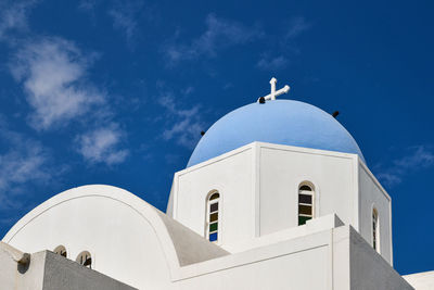 Low angle view of white building against blue sky