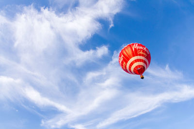 Low angle view of balloons flying against sky