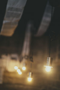 Close-up of light bulb hanging from ceiling