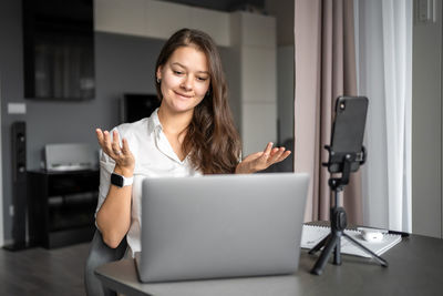 Young woman using laptop at home