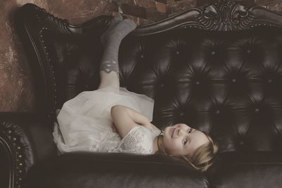 Young woman sleeping on sofa at home