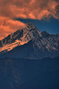 Scenic view of snowcapped mountains against sky during sunset