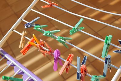 Multi colored christmas decorations hanging on clothesline