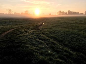 Scenic view of field against sky during sunset