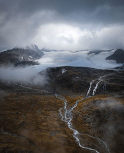 Scenic view of waterfall against sky