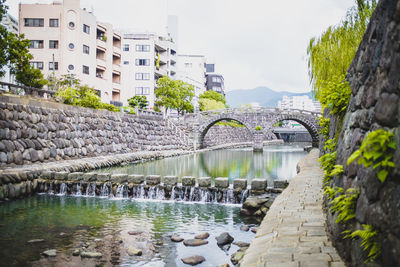 View of bridge over river against buildings