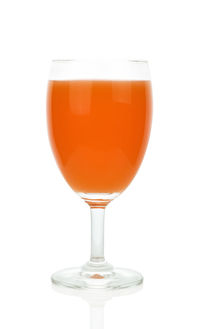 Close-up of beer in glass against white background