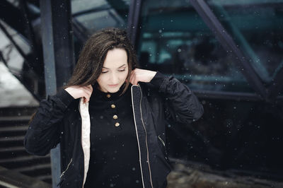 Young woman standing in city during winter