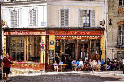 People at sidewalk cafe in city
