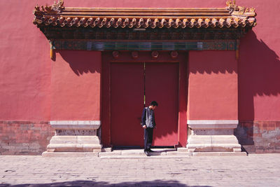 Full length of man standing at entrance of temple