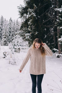 Full length of woman standing on snow covered land