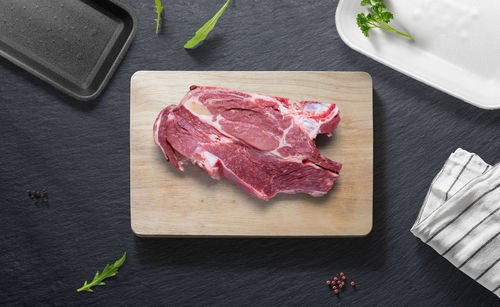 High angle view of meat on cutting board