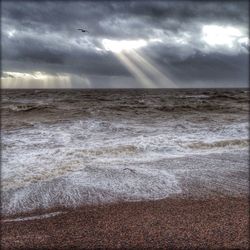 Scenic view of sea against cloudy sky