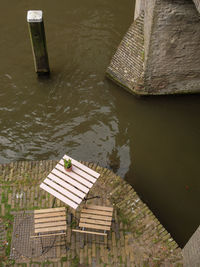 High angle view of bench in lake