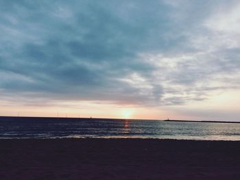 Scenic view of sea against cloudy sky