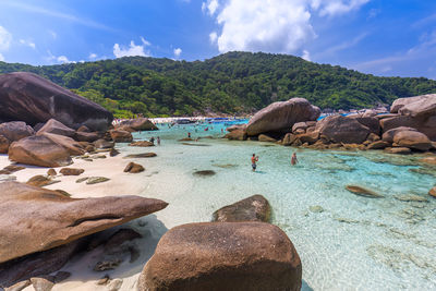 Rocks on beach against sky