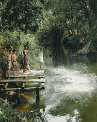 People on lake in forest