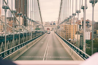 Vehicles on suspension bridge seen from windshield