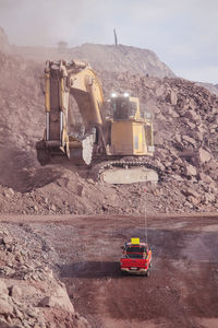 Big shovel loading of copper ore near to pickup truck