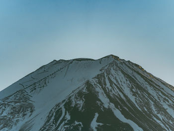 Scenic view of snowcapped mountains against clear sky