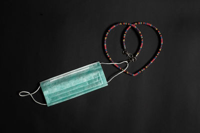 Close-up of heart shape on table against black background