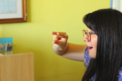 Portrait of young woman holding camera