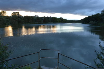 Scenic view of lake against cloudy sky