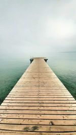 Pier over sea against sky